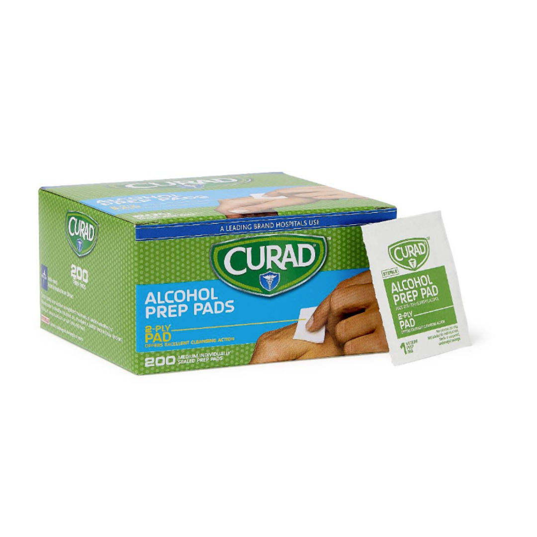 A green and blue box of Medline CURAD Medium 2-Ply Sterile Alcohol Prep Pads sits next to a single alcohol pad. The box contains 200 pads for skin cleansing, with images of hands using a pad on the packaging.